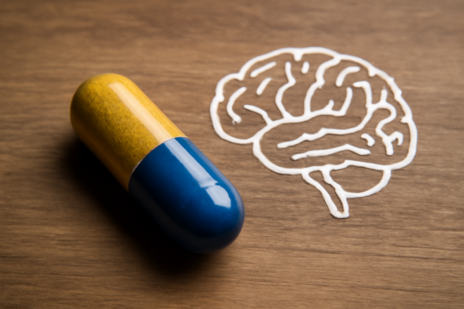 Brain diagram showing serotonin and norepinephrine signaling with a pill, for What Are SNRIs.